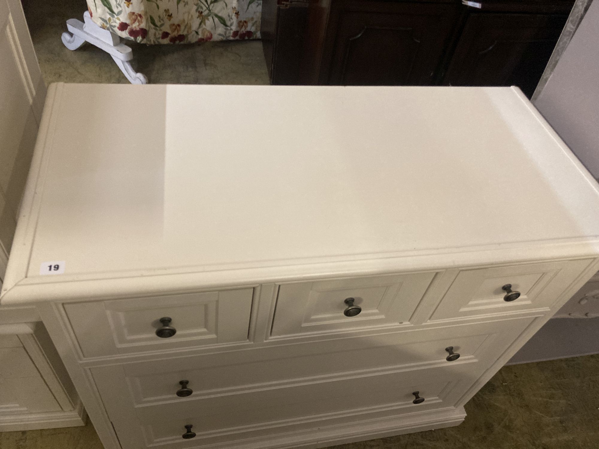 A contemporary white five drawer chest, together with a pair of matching three drawer bedside chests, larger width 105cm depth 50cm hei